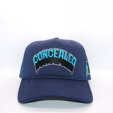 A navy blue front foam trucker panel with 'CONCEALED' embroidered in light blue and black on the front