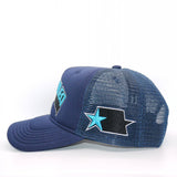 Side detail of the navy blue trucker cap with curved brim and star embroidered on the side mesh panel in light blue and black
